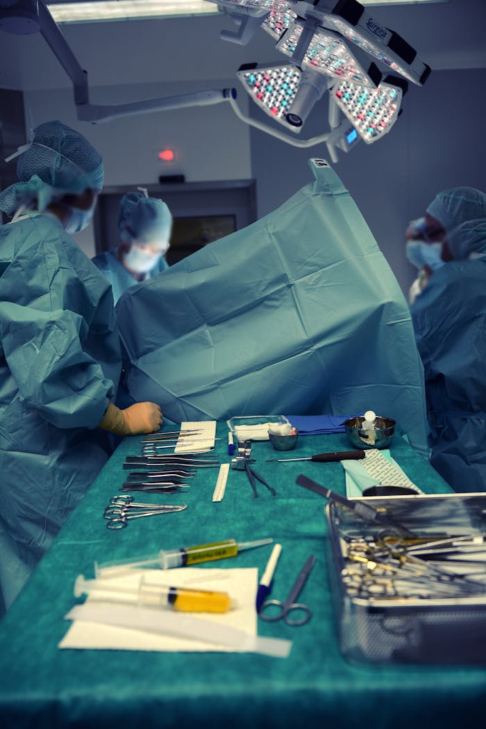 services-01 A team of surgeons in an operating room using various surgical instruments.