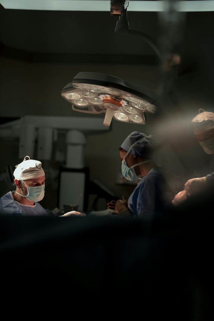 services-img Surgeons performing a precise surgical operation under operating room lights.